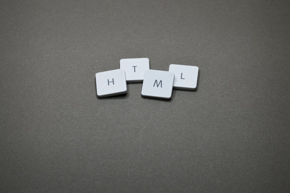A close-up image of four small, square, white tiles with black capital letters on their surfaces, arranged in a scattered manner on a plain, dark grey textured surface. The tiles display the letters 'H', 'T', 'M', and 'L', which are associated with web coding languages, and are positioned with slight overlaps and irregular spacing. The background surface has a matte finish, providing contrast to the smooth, glossy appearance of the tiles. The lighting is even, highlighting the flatness of the tiles and their clean edges without creating harsh shadows. This image appears to be a conceptual or decorative scene, not directly related to rubbish or waste management services. Occasionally, Waste Collection Harrow might use such visuals in content related to waste handling or alternative disposal methods, although this specific image does not depict waste materials or collection equipment. The composition emphasizes clarity and simplicity, suitable for accessibility and visual recognition purposes related to professional waste services or creative representations of digital concepts in waste sector communications.